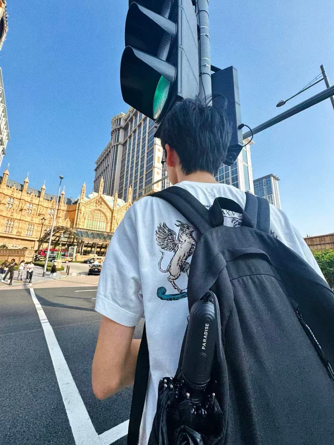 August walking through a city street with a backpack